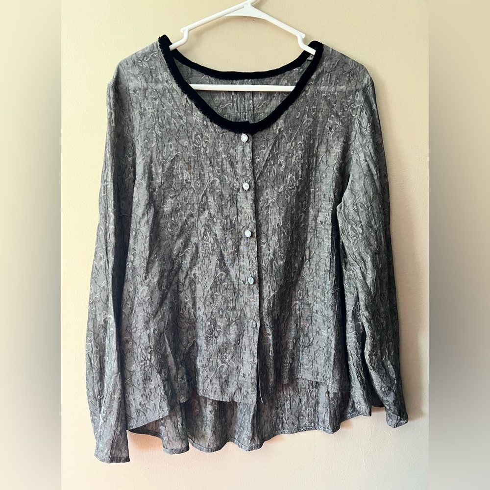 Grey semi sheer textured button up blouse with long sleeves and high low style.